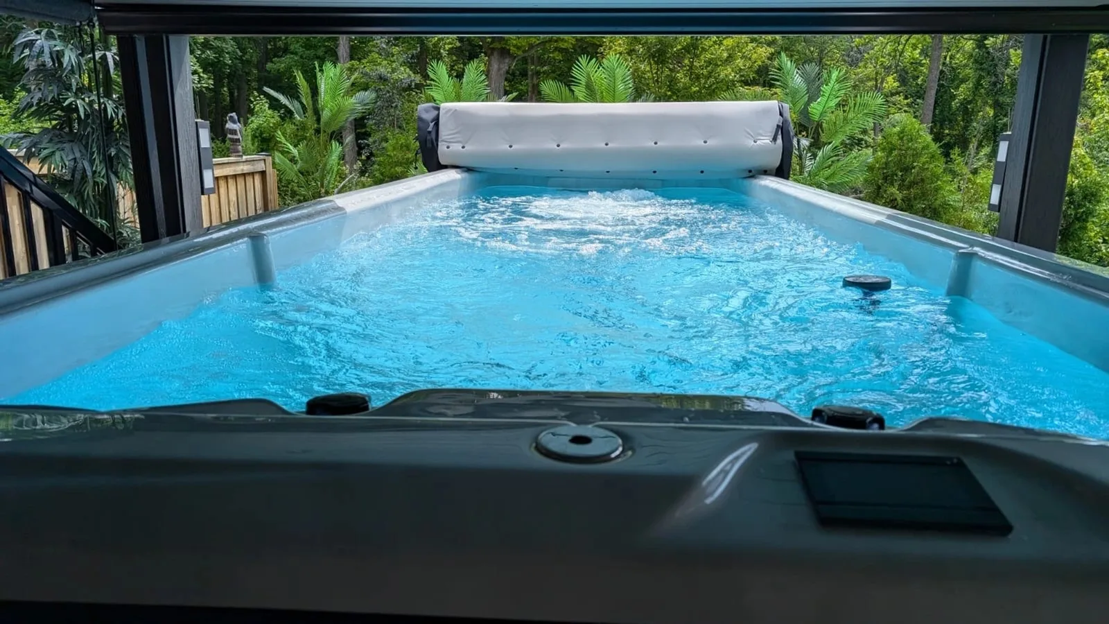 The 20ft Rothko swim spa installed in a backyard, lit at the waterline